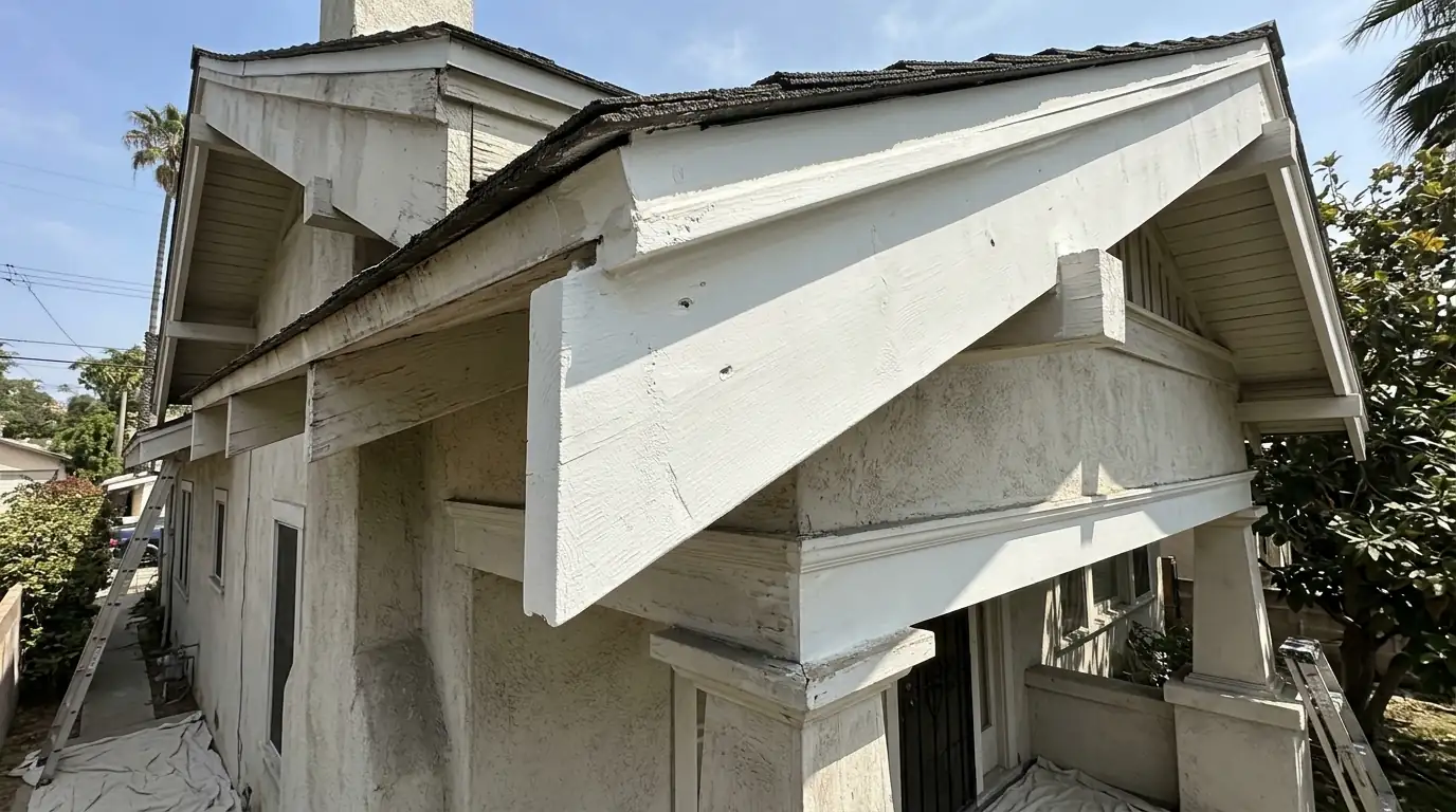 Newly repaired and primed eave and fascia boards on an older Los Angeles home after termite treatment, pestcontrolhuntingtonbeachca termite repair feature
